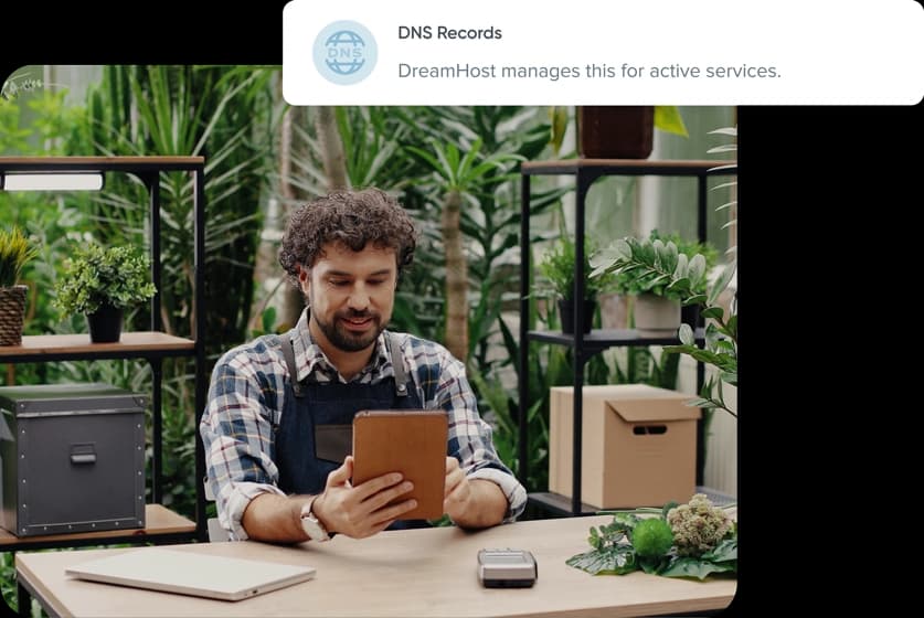 Man working on tablet in workshop setting and DNS Records tag
